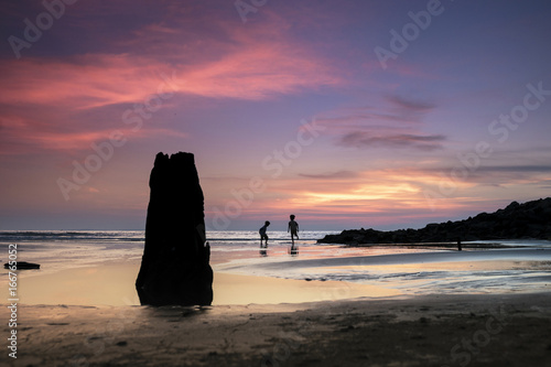Children, beach and twilight.