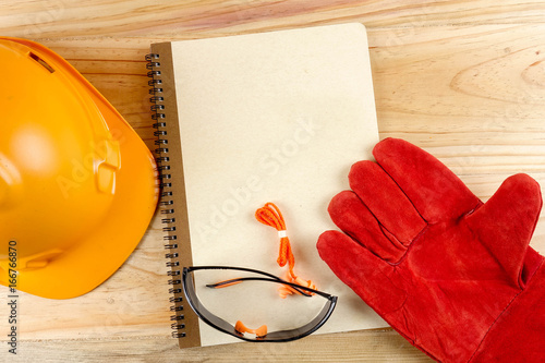 Safety hat,glove,glasses,ear plugs and note book. Health and safety concept.