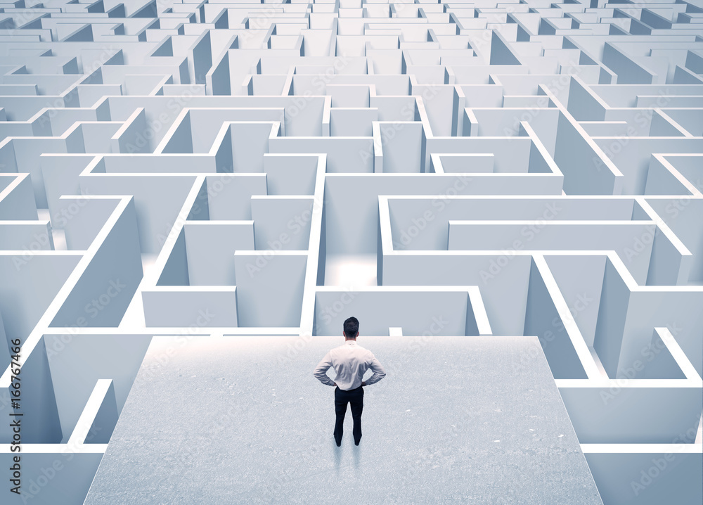 Businessman staring at infinite maze Businessman staring at infinite maze
