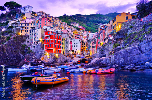 Riomaggiore village along the coastline of Cinque Terre area at dawn in Italy. photo