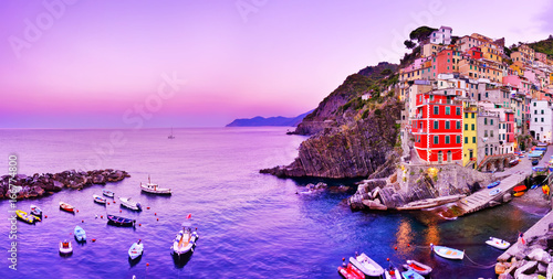 Riomaggiore village along the coastline of Cinque Terre area at dawn in Italy. photo