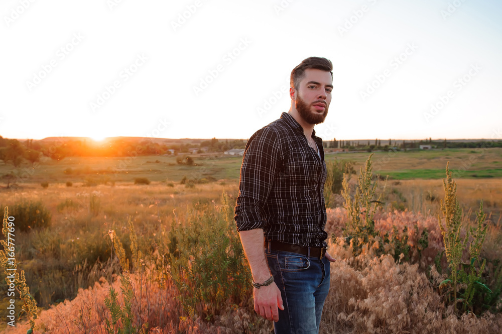 Handsome man on sunset background