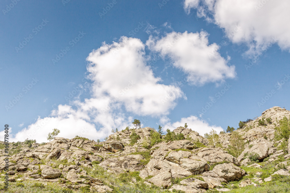 Beautiful mountain landscape, rocks and blue sky with clouds