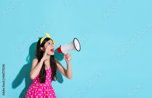 young smiling woman holding loudspeaker device