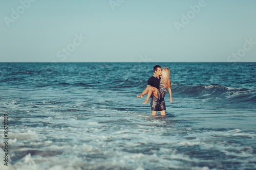 Young couple in love walking on the beach