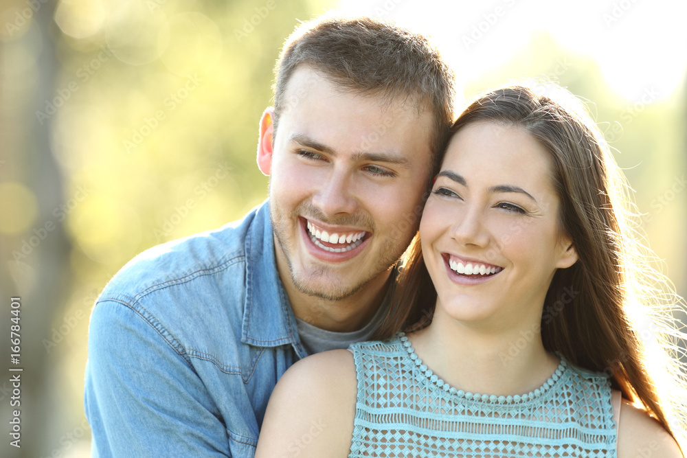 Happy couple with perfect smile looking at side Happy couple with perfect smile looking at side