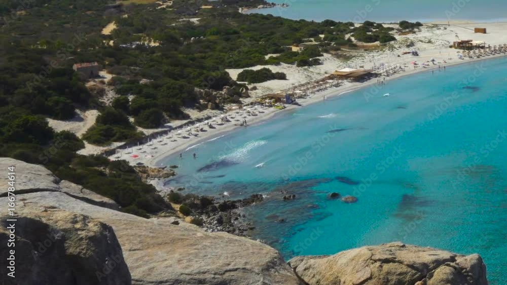 Scenic Sardinia Italy Mediterranean Sea Overlook with Clear Blue Water Bay Sandy Beach and Tourists Scenic Sardinia Italy Mediterranean Sea Overlook with Clear Blue Water Bay Sandy Beach and Tourists