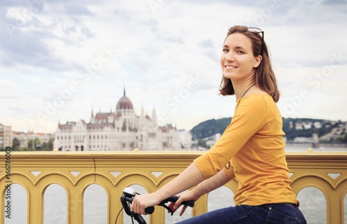 Young woman on bicycle in city