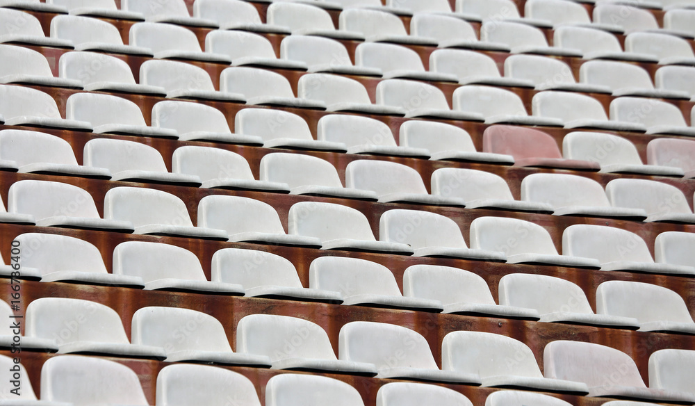 Obraz premium White seats on stadium bleachers with no people
