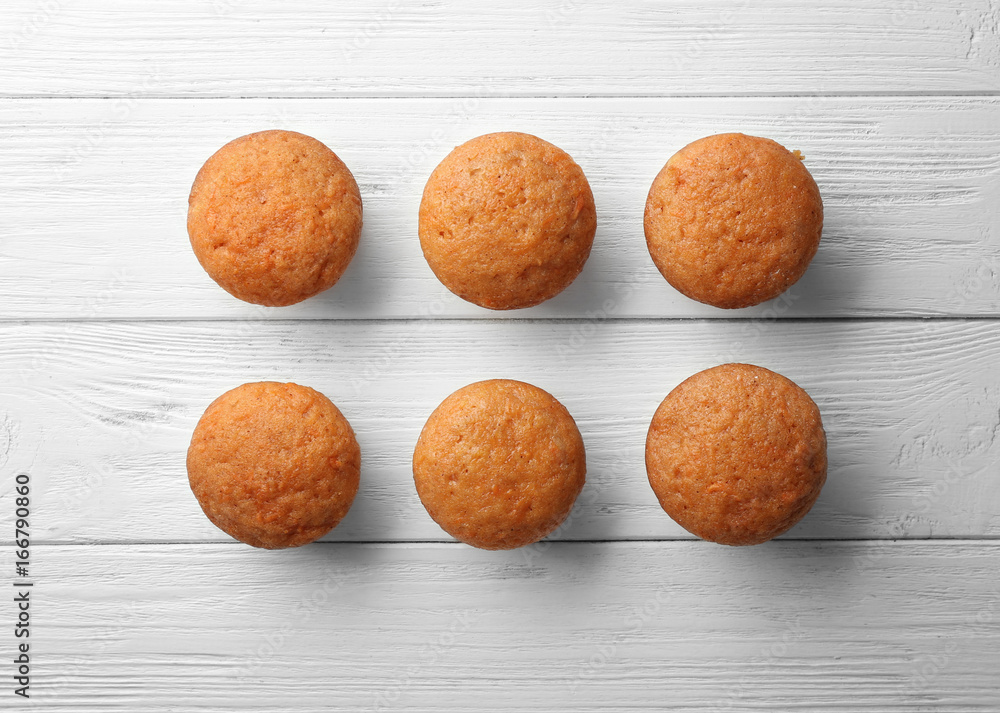 Delicious carrot muffins on wooden background Delicious carrot muffins on wooden background