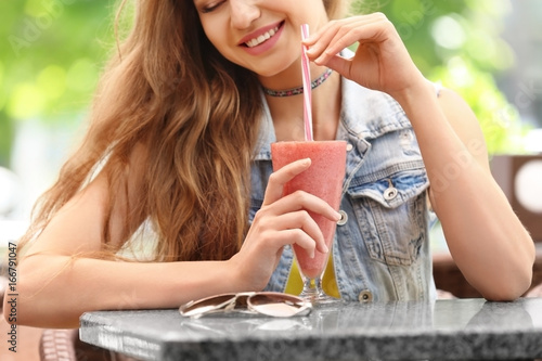 Pretty woman drinking tasty...