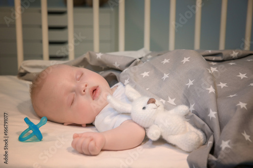 Obraz na plátně Adorable baby sleeping in cradle at home