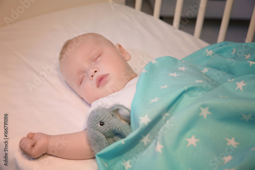 Adorable baby sleeping in c...