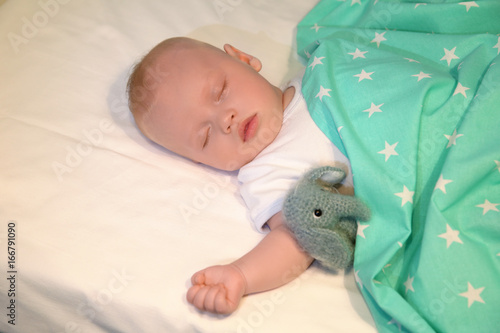 Adorable baby sleeping in c...