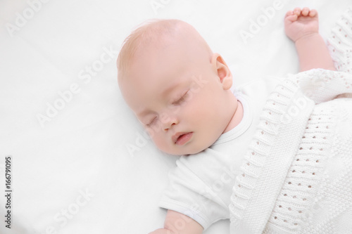 Adorable baby sleeping in c...