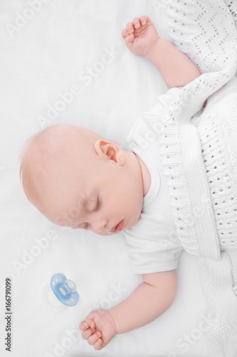 Adorable baby sleeping in cradle at home