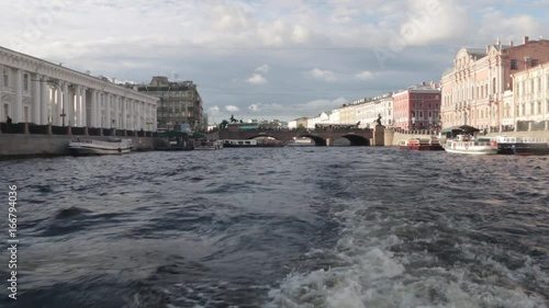 Boat trip on the rivers and Chanels of St. Petersburg. Tourists making photos on boat. Saint Petersburg in summer time. photo