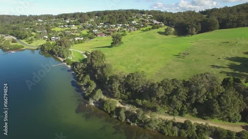 Cinematic round aerial pan with descend over river across beautiful Australian nature photo