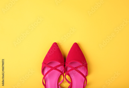 Stylish flat shoes on color background