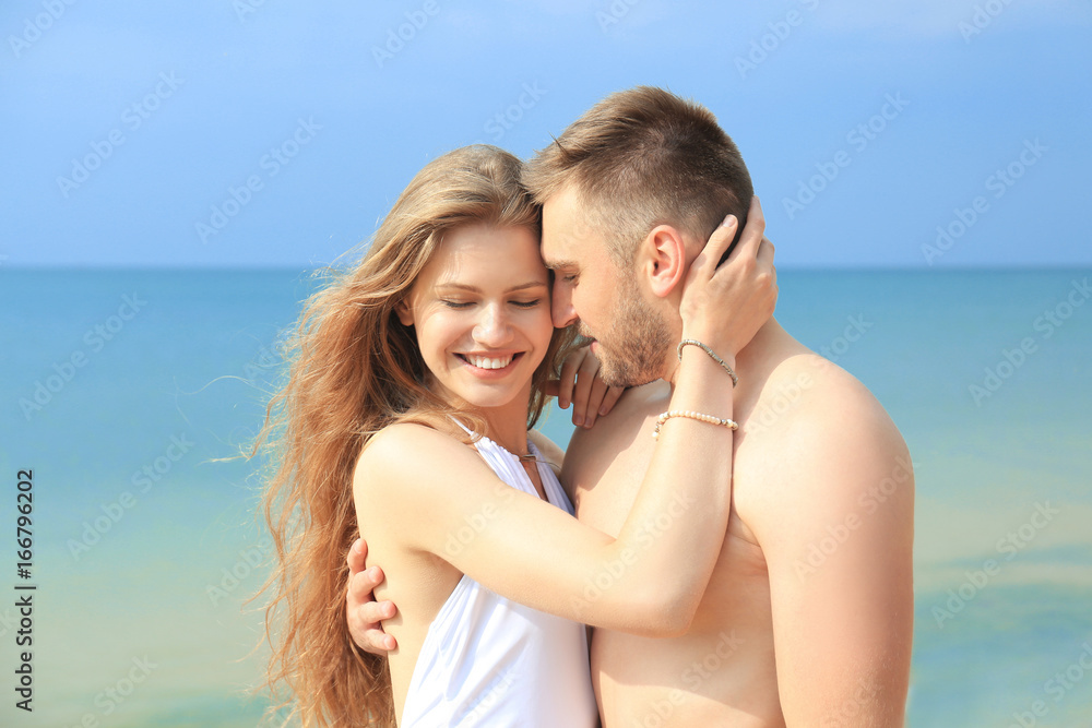 Young loving couple on seashore