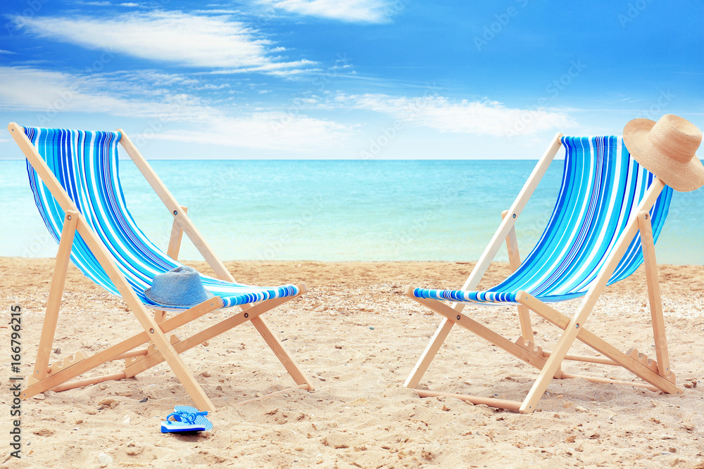Pair of beach chairs at sea shore. Vacation concept Pair of beach chairs at sea shore. Vacation concept