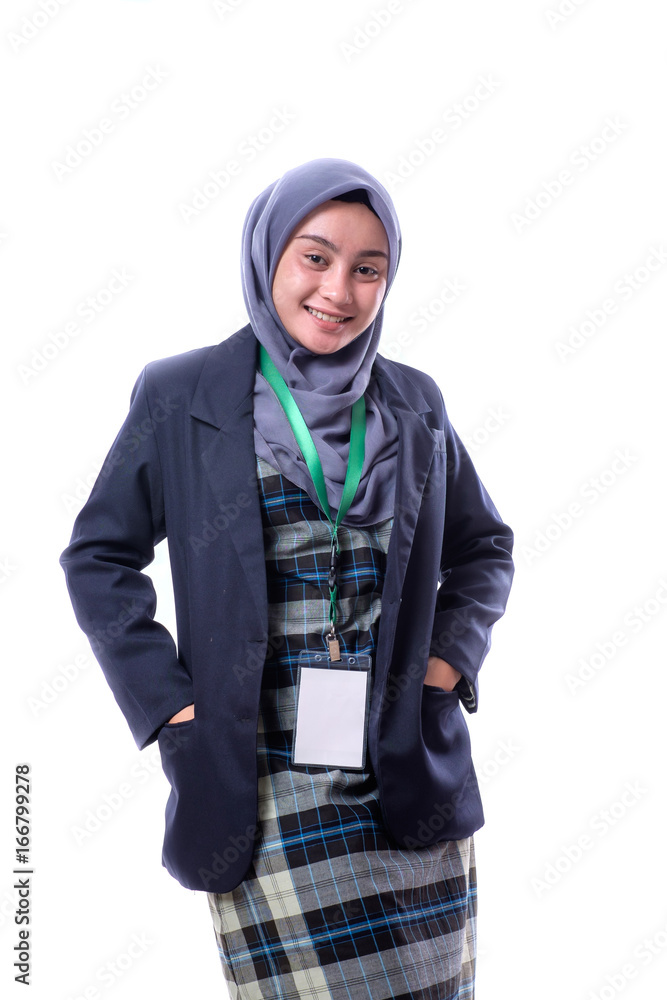 A pretty muslim woman wearing hijab, suit and wearing a blank ID tag or name card on a lanyard isolated on white background A pretty muslim woman wearing hijab, suit and wearing a blank ID tag or name card on a lanyard isolated on white background