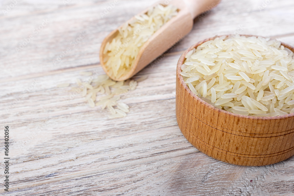 Jasmine rice in a bowl on wooden background Jasmine rice in a bowl on wooden background