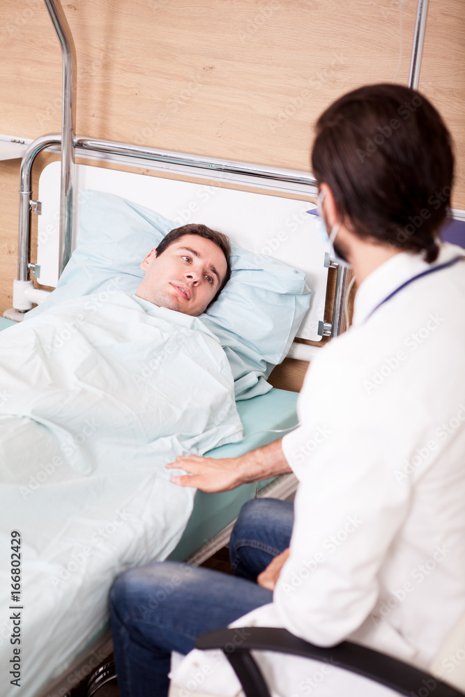 Fototapeta premium Doctor with patient in recovery room. Modern medicine and healthcare