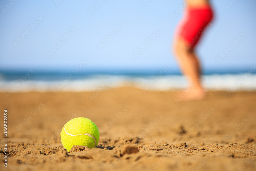 Tennis ball on a sandy beach