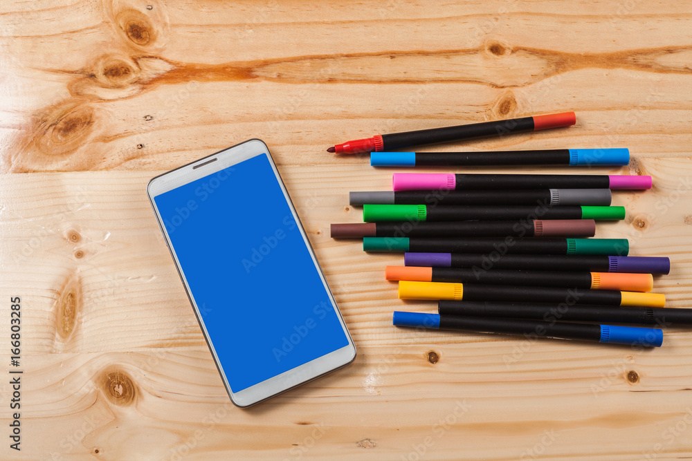 color pen and mobile phone on wood table . color pen and mobile phone on wood table .