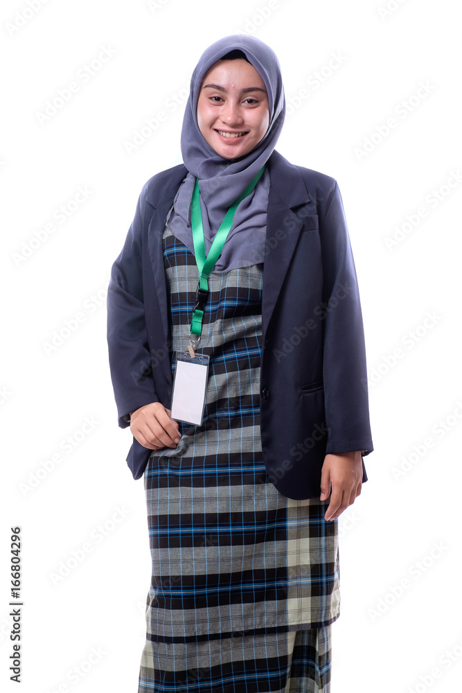 A beautiful, confident Muslim woman with a happy expression wearing hijab, suit and wearing a blank ID tag or name card on a lanyard holding cell phone isolated on white background. A beautiful, confident Muslim woman with a happy expression wearing hijab, suit and wearing a blank ID tag or name card on a lanyard holding cell phone isolated on white background.