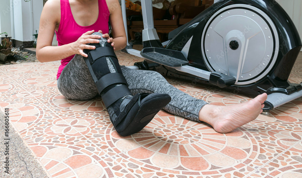broken leg injury woman wearing sportswear and ankle support leg