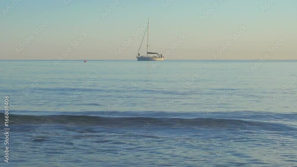 Mediterranean Rocky Bay and Wild Beach at Sunrise with Sailing Ship