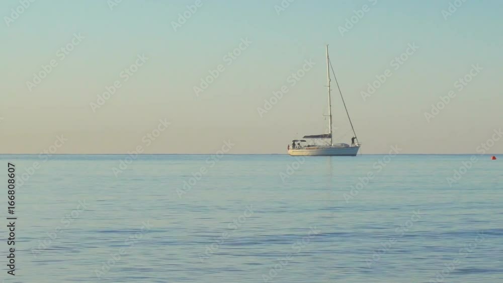 Mediterranean Rocky Bay and Wild Beach at Sunrise with Sailing Ship Mediterranean Rocky Bay and Wild Beach at Sunrise with Sailing Ship