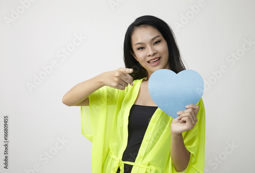 woman holding heart shape card board photo