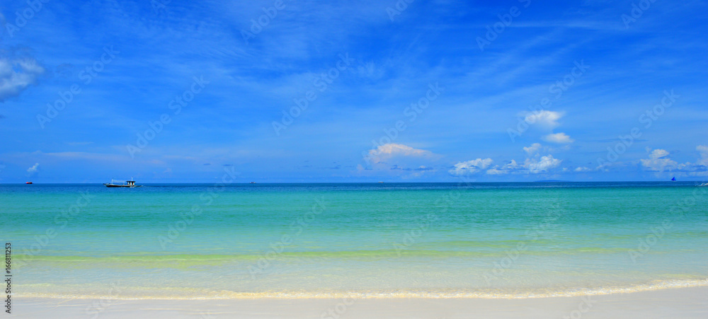 Pristine white beach, sea & blue sky meeting in horizon Pristine white beach, sea & blue sky meeting in horizon