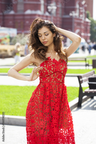 Beautiful brunette woman in sexy red dress