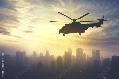 Army helicopter flying at sunrise time