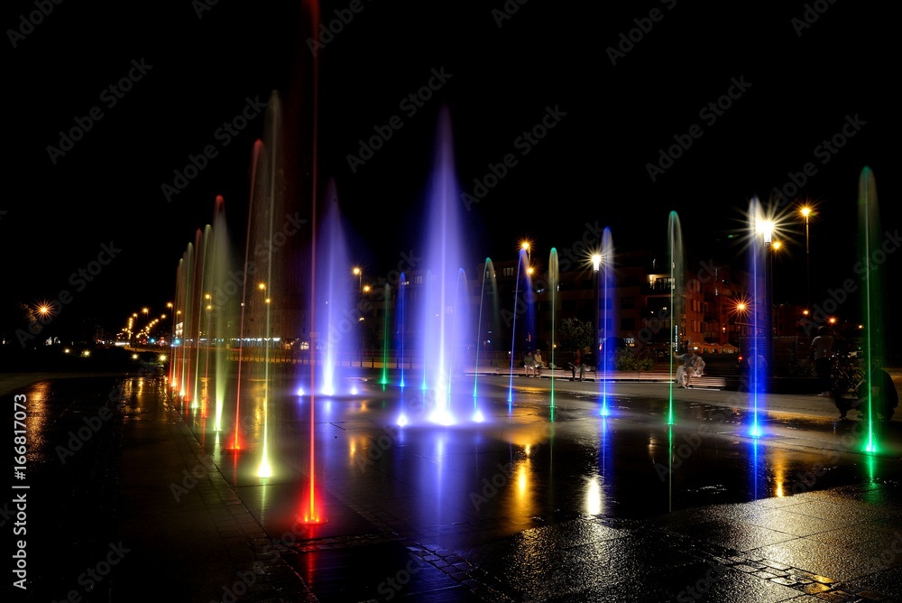 City fountain hot summer night and colorful illuminations