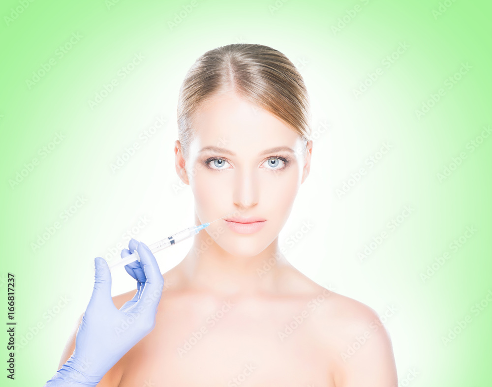 Young, beautiful and healthy woman having skin injections over green background. Plastic surgery concept. Young, beautiful and healthy woman having skin injections over green background. Plastic surgery concept.