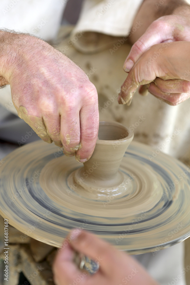 Potter with child making pottery