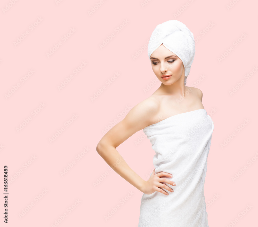 Young, beautiful and natural woman wrapped in towel over orange background. Young, beautiful and natural woman wrapped in towel over orange background.