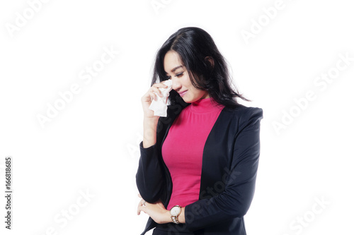 Beautiful businesswoman crying in the studio