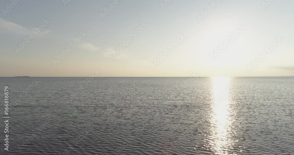 Aerial back fly over baltic sea in bright sunset time Aerial back fly over baltic sea in bright sunset time