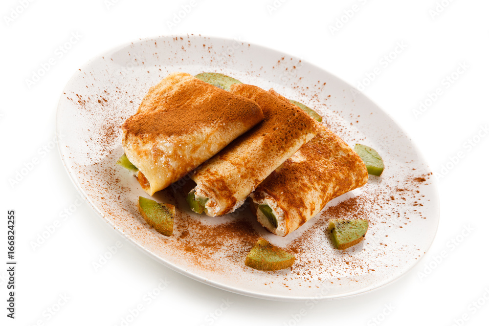Crepes with kiwi and cream on white background Crepes with kiwi and cream on white background