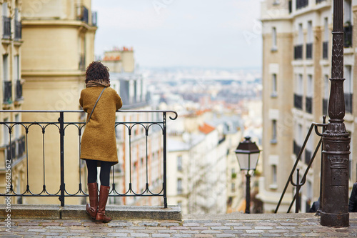 Photography Female tourist enjoying city view on a street of Montmartre