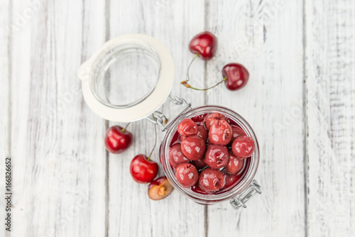 Fototapeta Naklejka Na Ścianę i Meble -  Fresh made Preserved Cherries on a rustic background