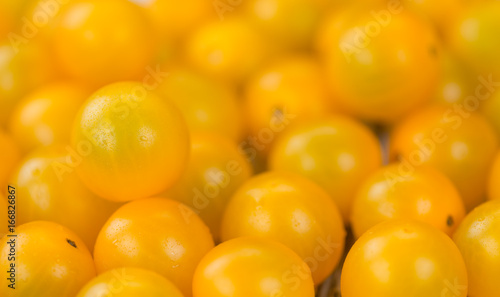 Wooden table with Yellow Tomatoes, selective focus
