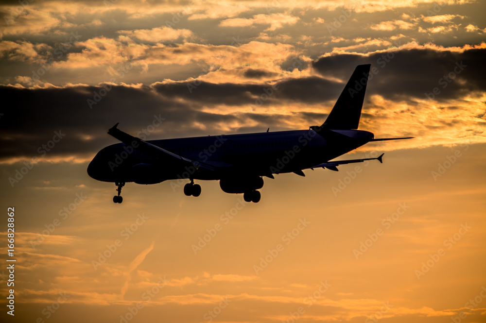Airplane landing at sunset Airplane landing at sunset