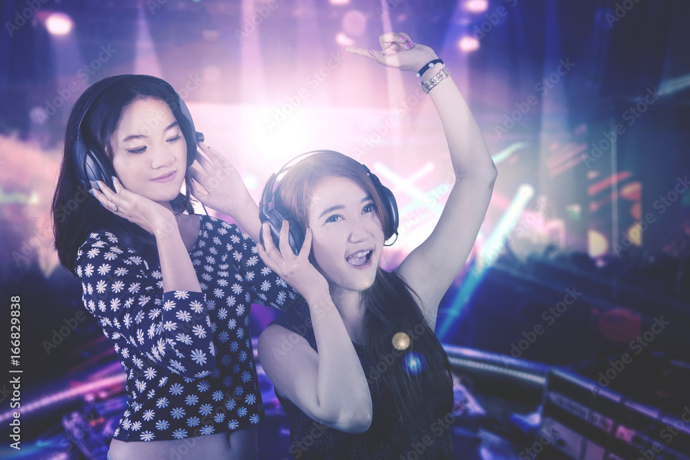 Two young DJ in the night party Two young DJ in the night party